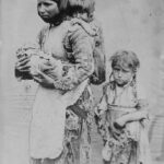 Photograph shows a poor, widowed Armenian woman and her children, Makarid (on her back) and Nuvart (standing next to her).
