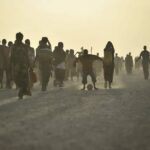 A young boy plays football on a road at an IDP camp near the town of Jowhar, Somalia. AU UN IST PHOTO / Tobin Jones. The African Union Mission in Somalia (Source).